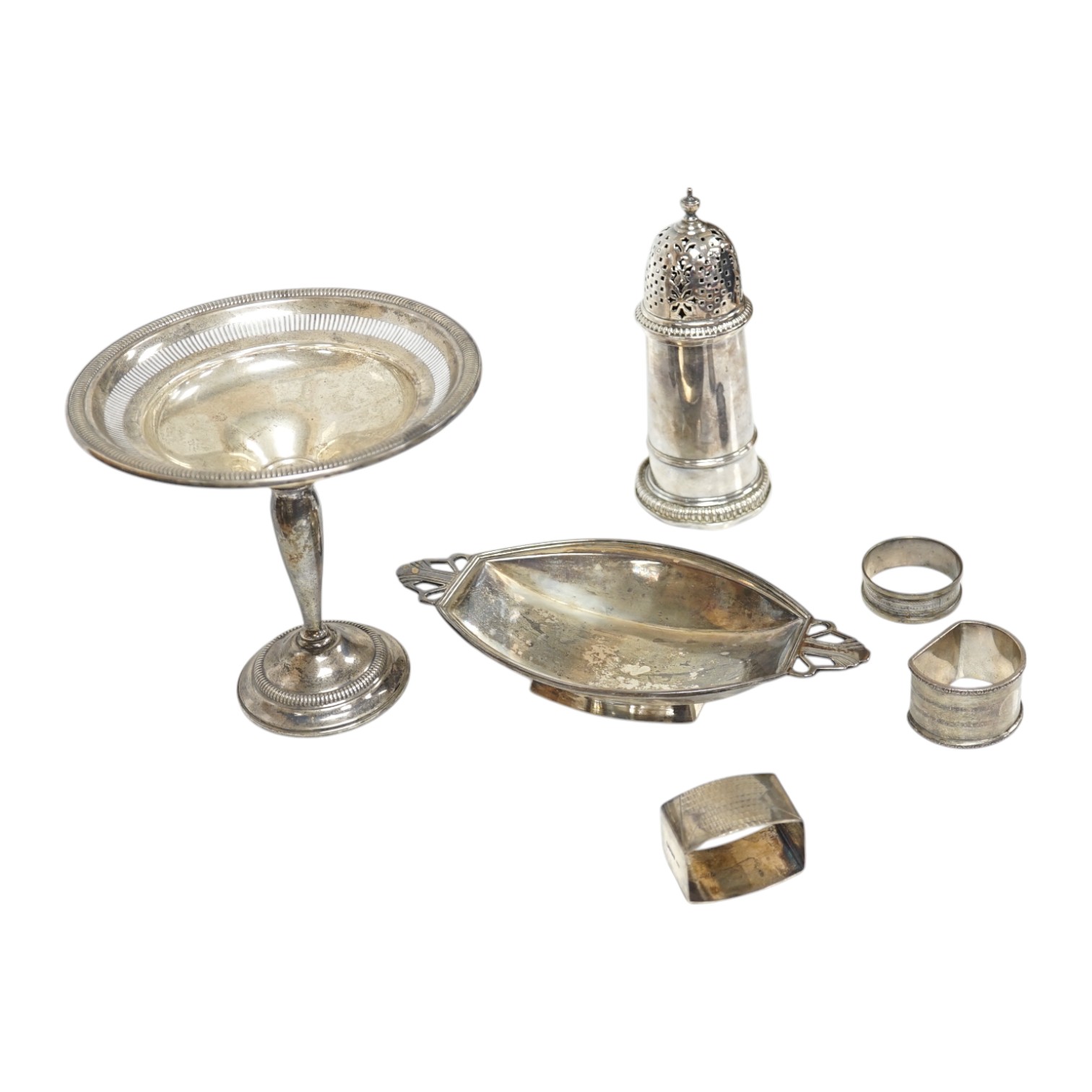 A George VI Art Deco silver two handled dish, Birmingham, 1939, 21.1cm, together with three assorted silver napkin rings, a modern silver sugar caster and a weighted sterling tazza. Condition - poor to fair